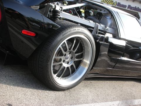 1998 Ford Crown Victoria - Photograph of a black Ford GT's rear wheel, tire and suspension, not a technical document.