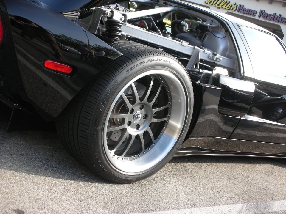 Rear wheel and suspension detail of a black Ford GT supercar