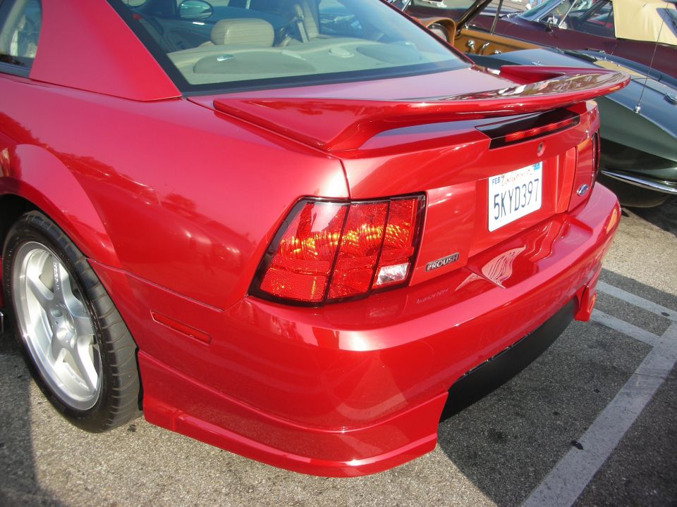 Rear of a red Roush Mustang showing spoiler and California plate