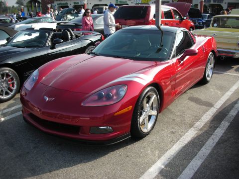 1998 Ford Crown Victoria - Photograph of a red C6 Chevrolet Corvette coupe at a car show, not a technical document.