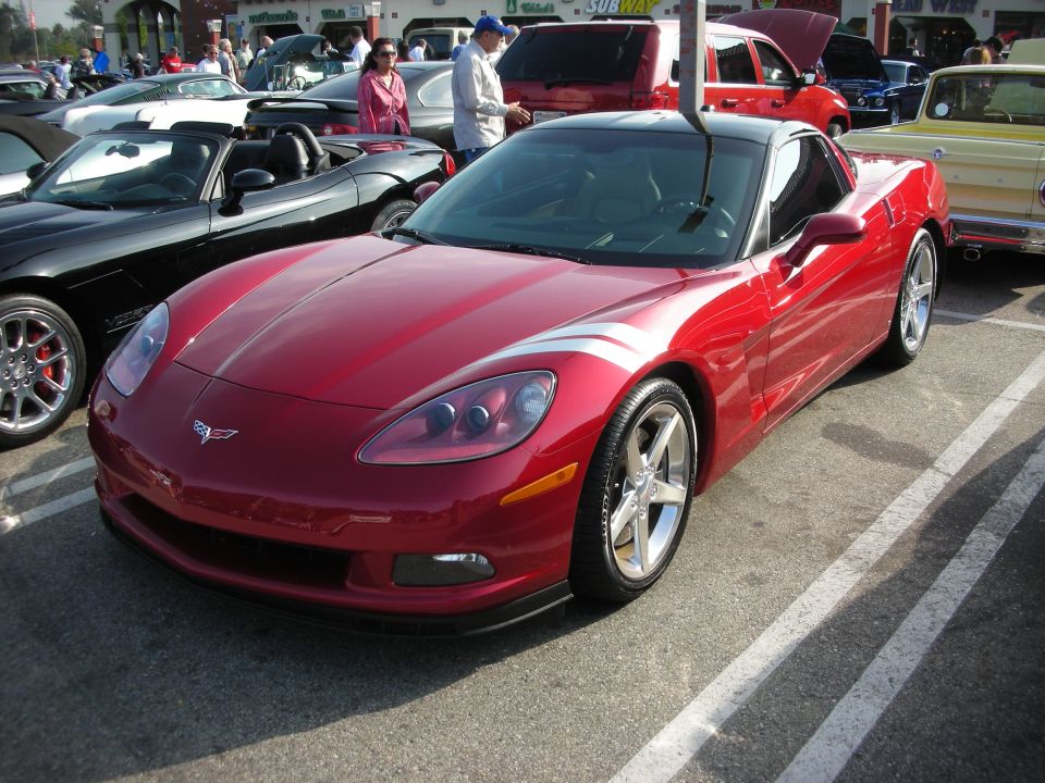 Red C6 Chevrolet Corvette coupe in a parking lot