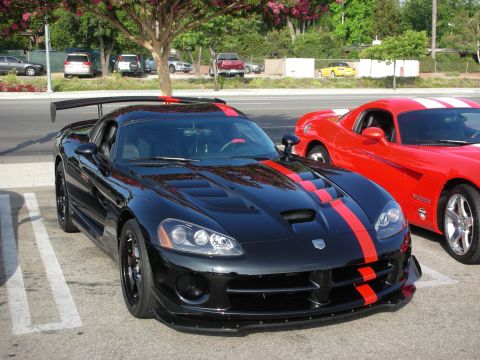 1998 Ford Crown Victoria - Photograph of a black Dodge Viper ACR with red stripes and a wing at a car show, not a technical document.