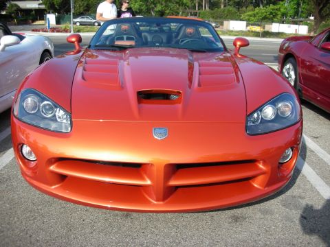 1998 Ford Crown Victoria - Photograph of the front of a copper-orange Dodge Viper roadster, not a technical document.