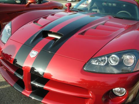 1998 Ford Crown Victoria - Photograph of the hood and front of a red Dodge Viper with black stripes, not a technical document.