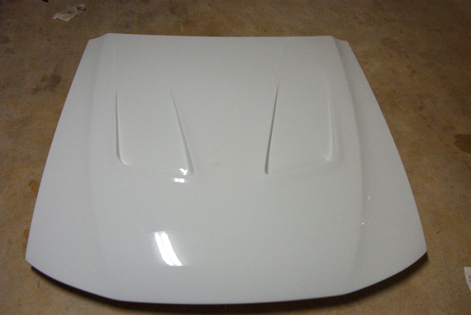 White car hood with two raised vents, possibly aftermarket