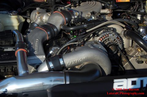 1992 Ford Crown Victoria - Close-up view of a modified engine bay featuring a Paxton supercharger and Vortech intake components. The engine is installed in a vehicle,…