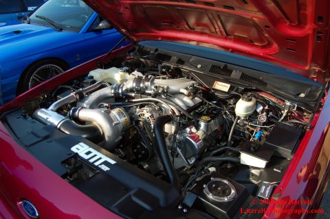 1992 Ford Crown Victoria - Customized engine bay a turbocharger, with another vehicle visible.