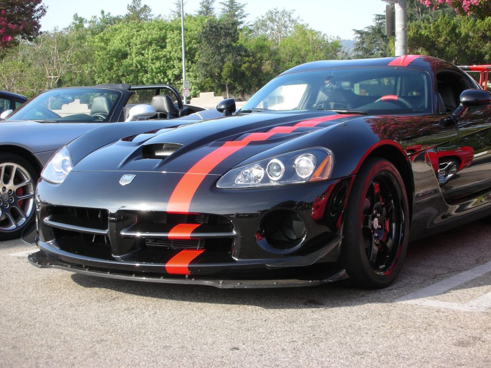 Front of a black Dodge Viper with orange stripes and black wheels