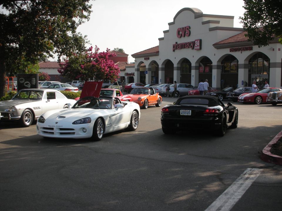 White and black Dodge Vipers parked in front of a CVS pharmacy