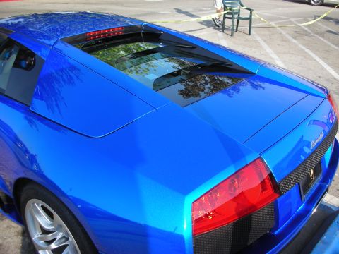 1998 Ford Crown Victoria - Close-up of a metallic blue Lamborghini Murcielago rear quarter, engine cover and taillight.