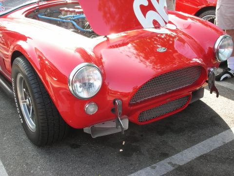 1998 Ford Crown Victoria - Photograph of the front of a red Shelby Cobra roadster, not a technical document.