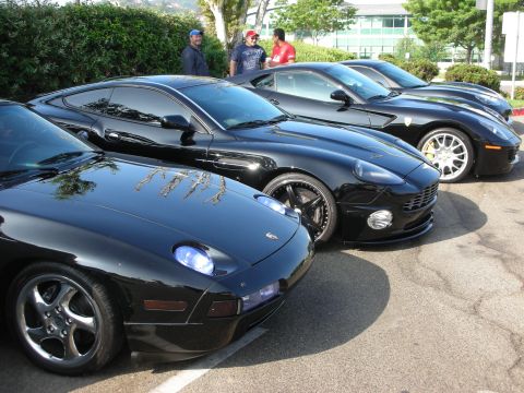 1998 Ford Crown Victoria - Several blue sports cars are parked in a row, with their front ends facing the camera.