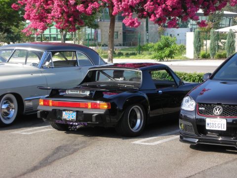 1998 Ford Crown Victoria - Three cars parked together: a black Porsche 914, a vintage car, and a Volkswagen GTI.