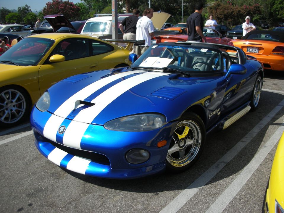 Front of a blue Dodge Viper with white stripes at a car show