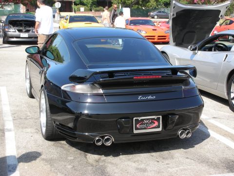 1998 Ford Crown Victoria - Photograph of a black Porsche 911 Turbo at a car show, not a technical document.