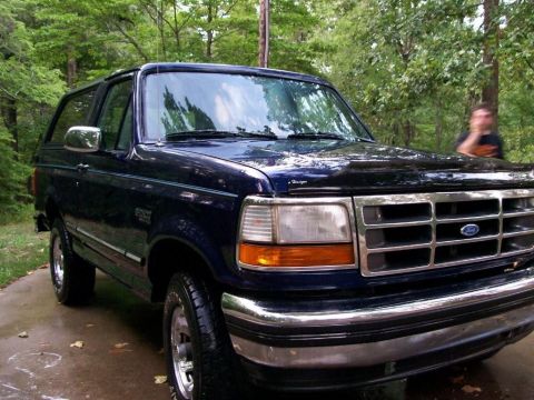 1994 Ford Bronco - This 1994 Ford Bronco is shown from a 3q-front angle, its dark blue paint and chrome grille.
