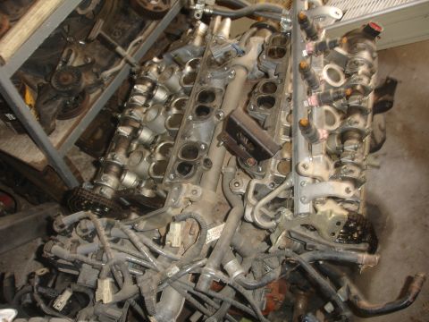 1993 Ford Taurus - This is a disassembled engine, likely for repair or parts, showing the intricate network of fuel lines and electrical connectors.