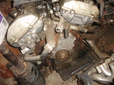 1993 Ford Taurus - Engine components are visible, including a block, covers, and hoses, with a spring in the foreground.