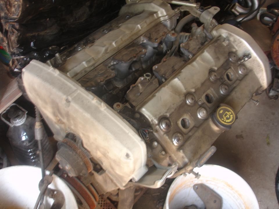 Engine part with yellow cap showing Ford logo
