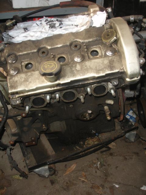1993 Ford Taurus - Engine valve cover and exhaust manifold ports are visible in this close-up.