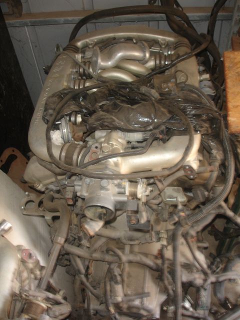 1993 Ford Taurus - Engine assembly, likely removed from a vehicle, with visible intake manifold and wiring.