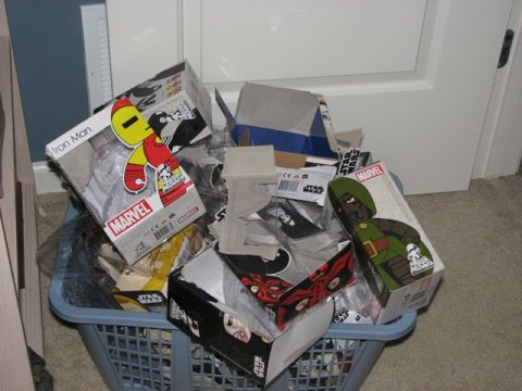 1991 Ford Bronco - A collection of Marvel and Star Wars toy boxes are piled inside a blue laundry basket.