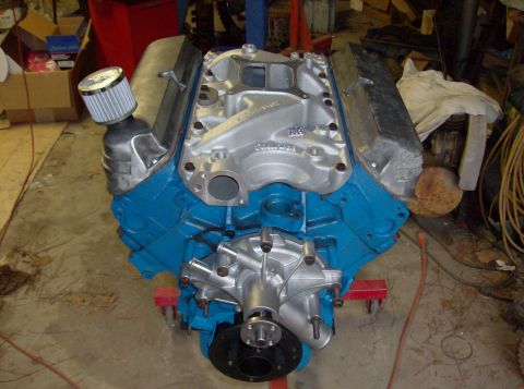 1989 Ford Bronco - A Ford V8 engine is shown on an engine stand, painted blue with silver components.