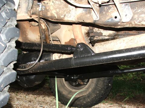 1996 Ford Bronco - Close-up view of the undercarriage of a vehicle, highlighting its suspension and exhaust system.