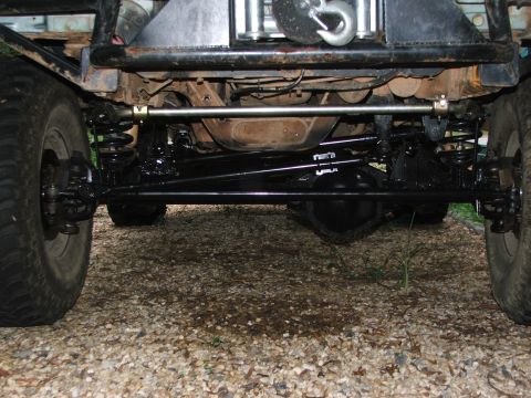 1996 Ford Bronco - Close-up view of the front suspension and steering linkage of an off-road vehicle.