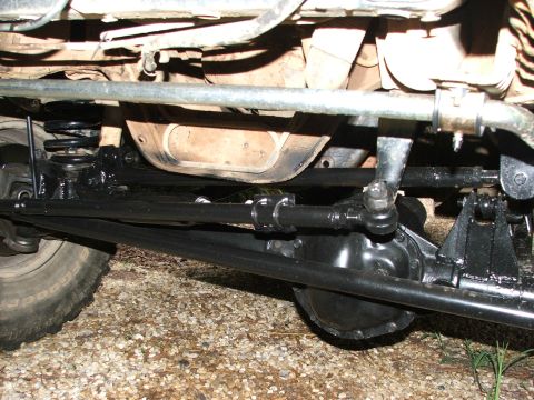 1996 Ford Bronco - Close-up view of the vehicle's steering and suspension system, with a tire visible on the left side.