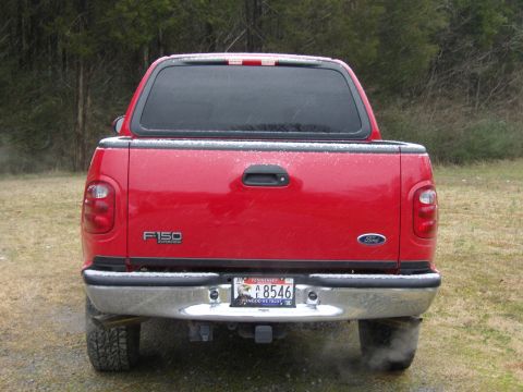 2007 Ford Mustang - Photograph of the rear of a red Ford F-150 pickup showing tailgate and license plate.