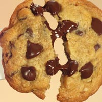1992 Ford Bronco - A close-up, overhead shot of a chocolate chip cookie that has been broken in half, revealing melted chocolate chips and a soft, doughy inte…