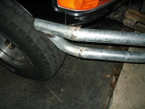 1993 Ford Bronco - Close-up of the front corner of a 1993 Ford Bronco, showing a custom winch bumper and tire. The registry label is correct.