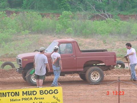 1989 Ford Bronco - This early 1980s SUV is seen at a mud bog event with three people present.