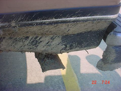 1989 Ford Bronco - Close-up of a dirty exhaust pipe and bumper, likely from off-roading.