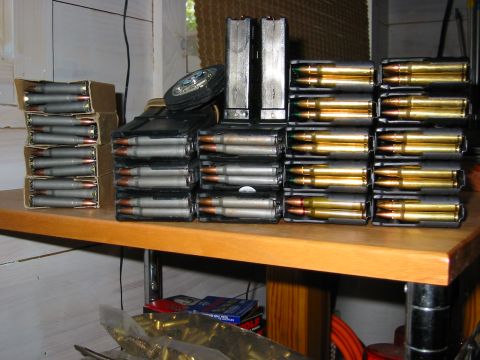 1996 Ford Bronco - A wooden shelf holds multiple stacks of VHS tapes, some in cases and some loose.