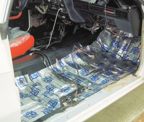 1976 Ford Ranchero - Interior of a car undergoing sound deadening installation on the floor pan.