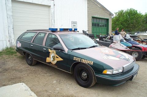1991 Ford LTD Crown Victoria - Photograph of a State Trooper-liveried Chevrolet Caprice station wagon, not a technical document.