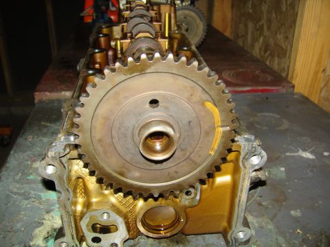 2007 Ford Mustang - Photograph of the end of an engine cylinder head showing a timing gear and camshaft.