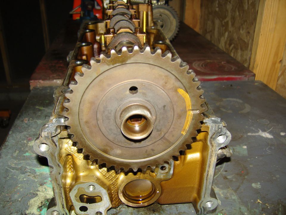 Engine cylinder head end view showing timing gear and camshaft