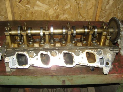 2007 Ford Mustang - Photograph of a cylinder head showing camshafts, valvetrain and intake port flange, not a technical document.
