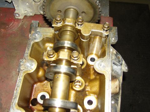2007 Ford Mustang - Photograph of a cylinder head close-up showing a camshaft, timing gear and bearing caps, not a technical document.