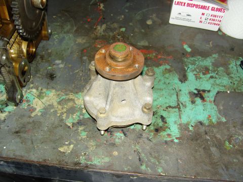 2007 Ford Mustang - Photograph of a removed engine water pump on a workbench, not a technical document.