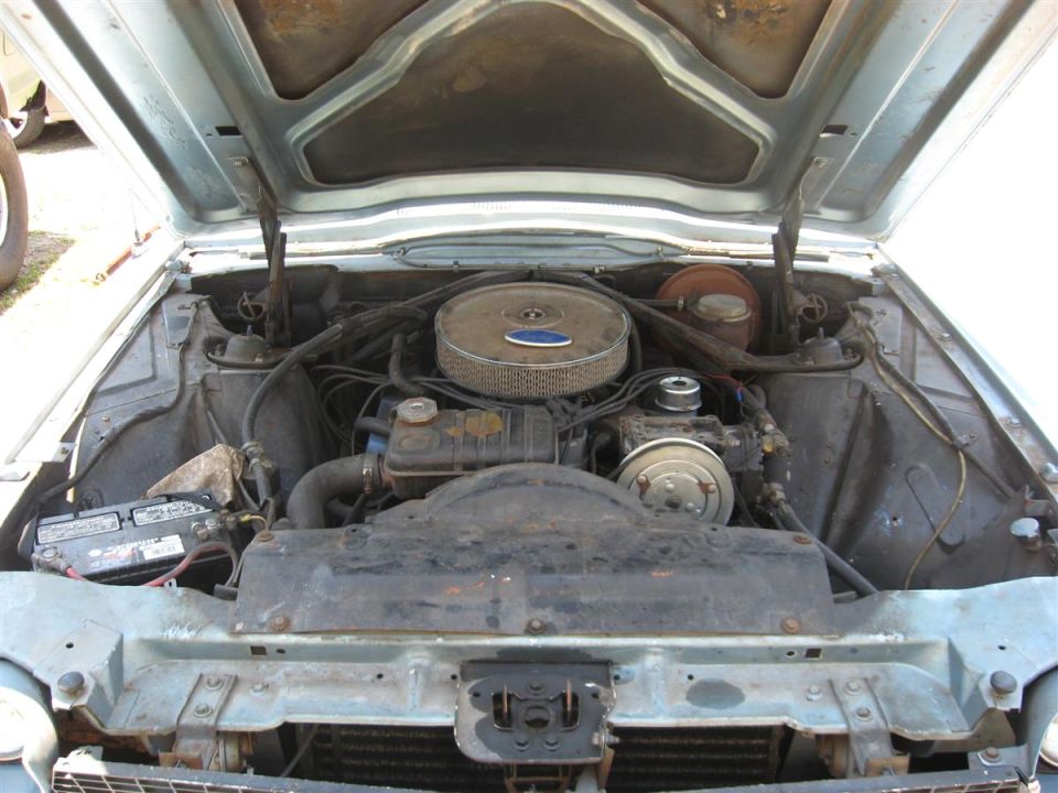 1966 Ford Thunderbird engine bay with V8 engine, chrome air cleaner, and battery.