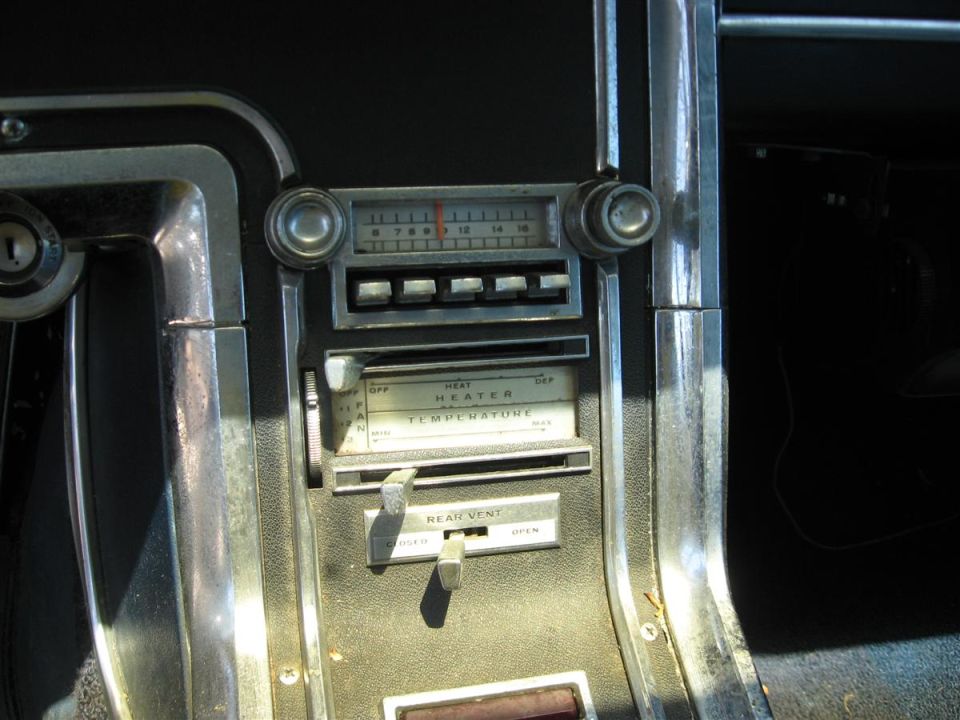 Classic car center console with radio, heater temperature slider and rear vent control