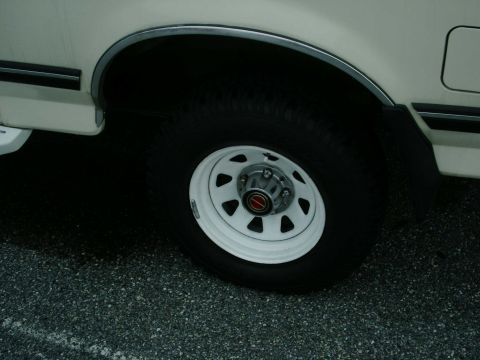 1988 Ford Bronco - Close-up of a white wheel and fender on a vintage Ford Bronco.