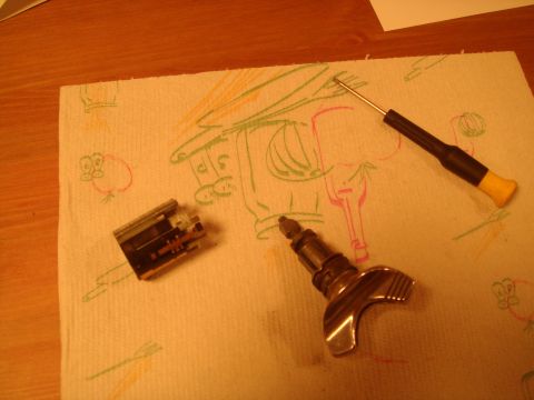 1992 Ford Bronco - Disassembled car ignition lock cylinder and key tumbler components laid out on a paper towel.