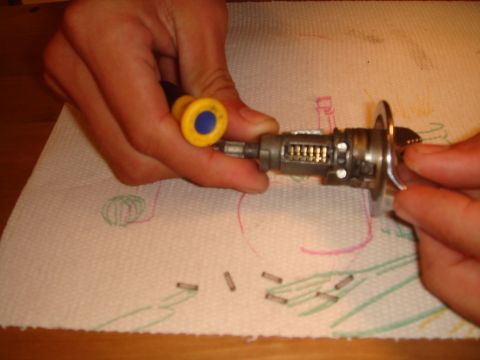 1992 Ford Bronco - Car ignition lock cylinder and springs are laid out on a paper towel, possibly for rekeying.