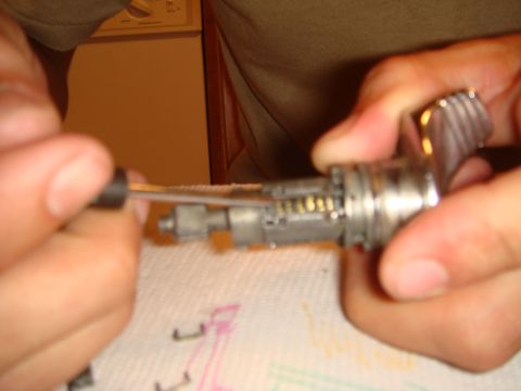 1992 Ford Bronco - Close-up of an ignition lock cylinder with pins visible, being worked on with a tool.