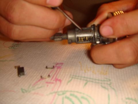 1992 Ford Bronco - Servicing an ignition lock cylinder, showing internal pins and components.